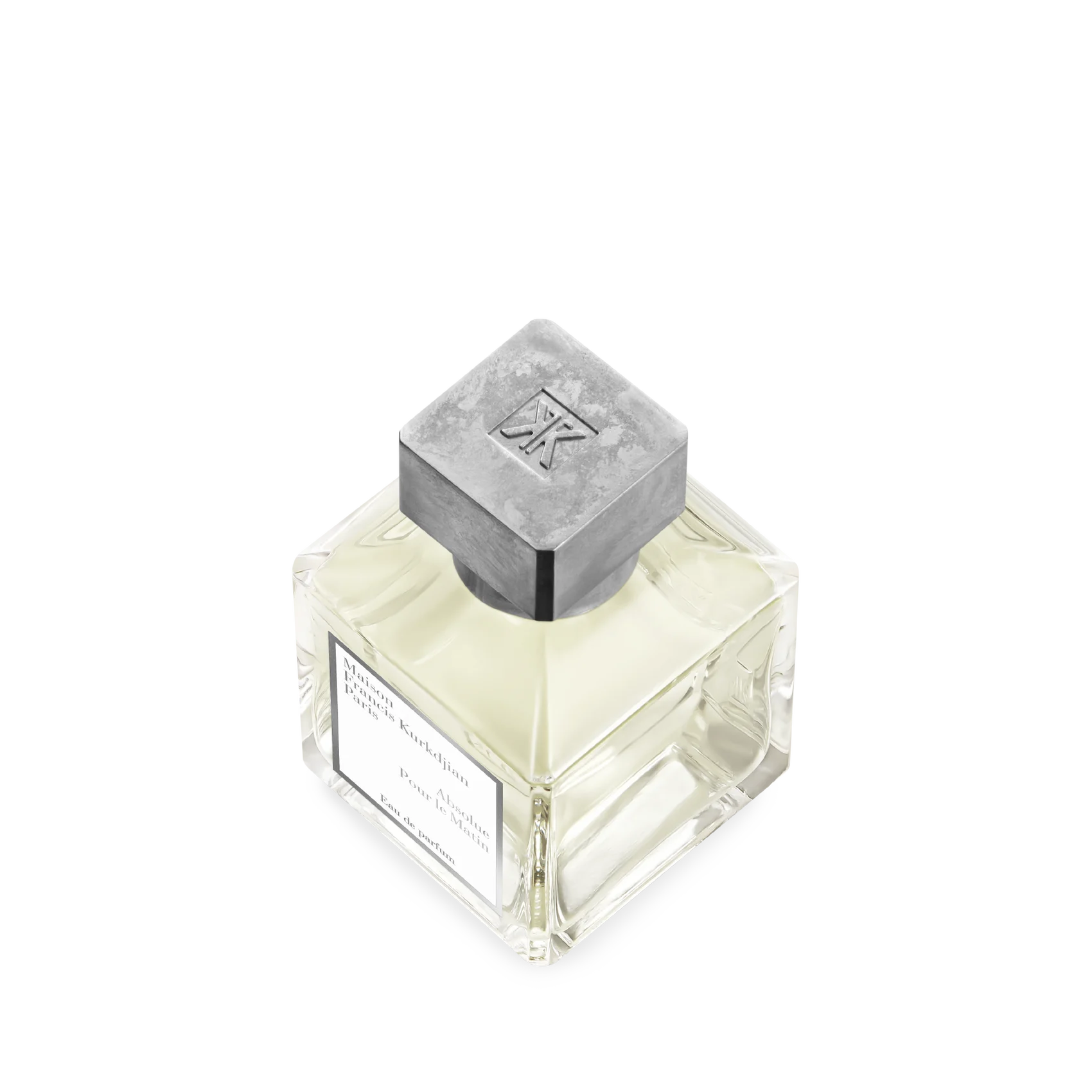 Square glass perfume bottle with pale yellow liquid, a white label, and a distressed grey square cap with an embossed 'MK' lo