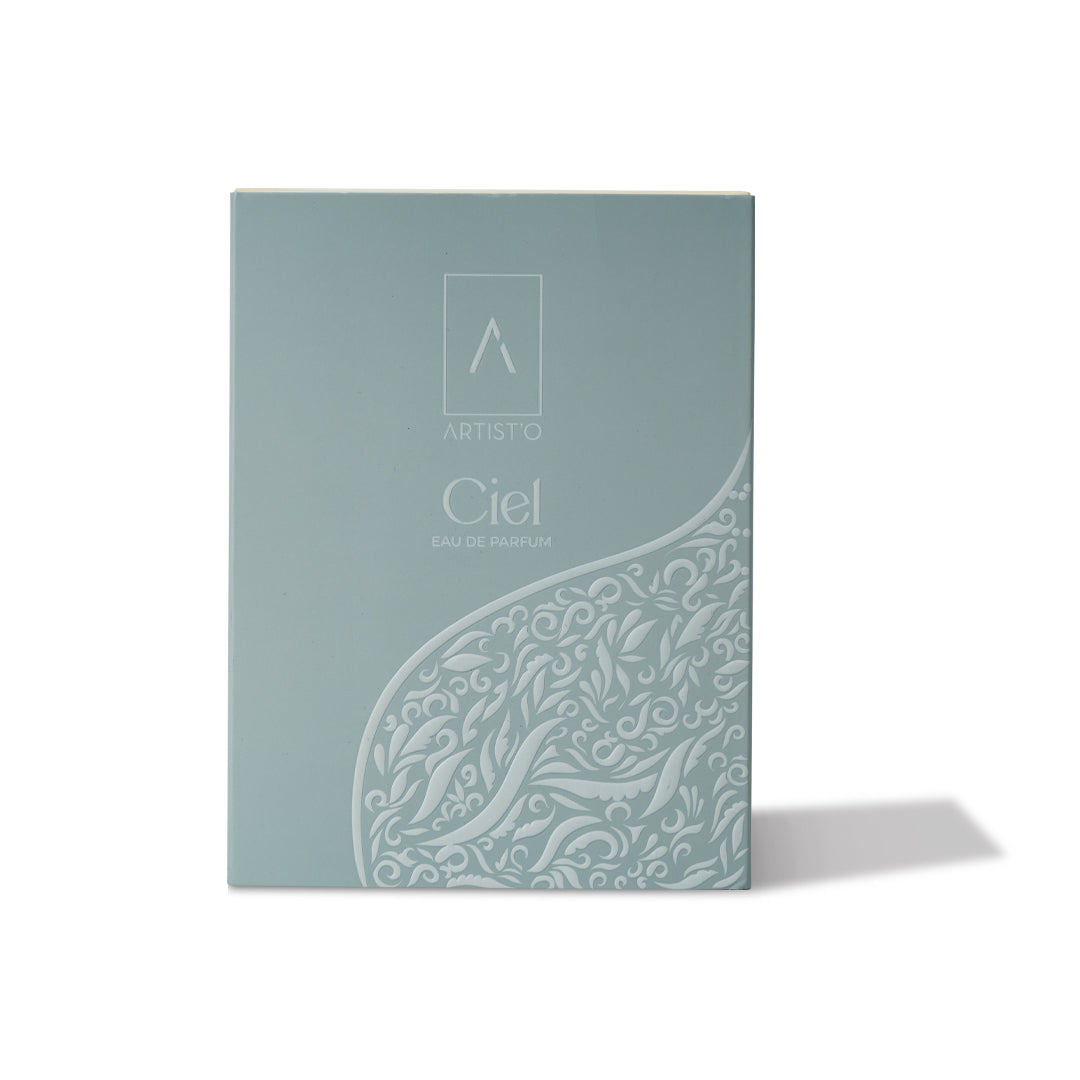 Artist’O Ciel Eau de Parfum in an ornate clear glass bottle with soft blue luxury packaging, showcasing a fresh and elegant fragrance design – Available for Online Purchase