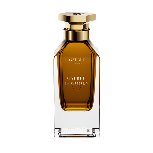A front-facing view of the Galbee Is Woody perfume bottle, highlighting the gold-etched branding and the signature hexagonal emblem on the glass.