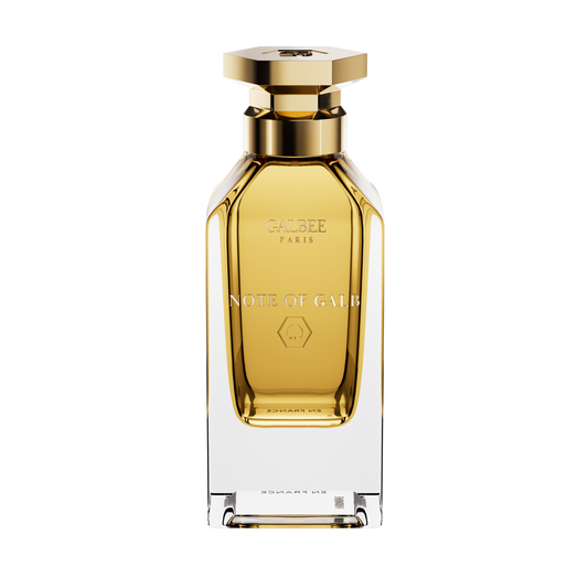 A front view of the Galbee Paris Note of Galb perfume bottle, featuring a clear glass exterior, a golden interior, and a gold hexagonal cap.