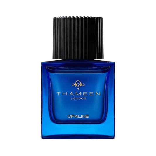 Blue rectangular glass perfume bottle with a black ribbed cap and gold-toned THAMEEN logo.