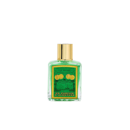 L.T. Piver Un Parfum d’Aventure Eau de Parfum 100ml bottle with gold cap displayed beside a deep green vintage-style box with ornate French artwork, Exclusive Online.