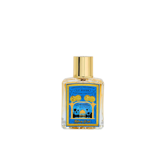 L.T. Piver Rêve d’Or Eau de Parfum 100ml bottle with gold cap displayed beside a blue and gold vintage-style box featuring ornate French artwork, Shop Now Online.