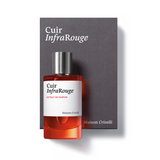 A bottle of Maison Crivelli Cuir InfraRouge Extrait de Parfum with vibrant reddish-orange liquid, displayed in front of its charcoal grey presentation box.