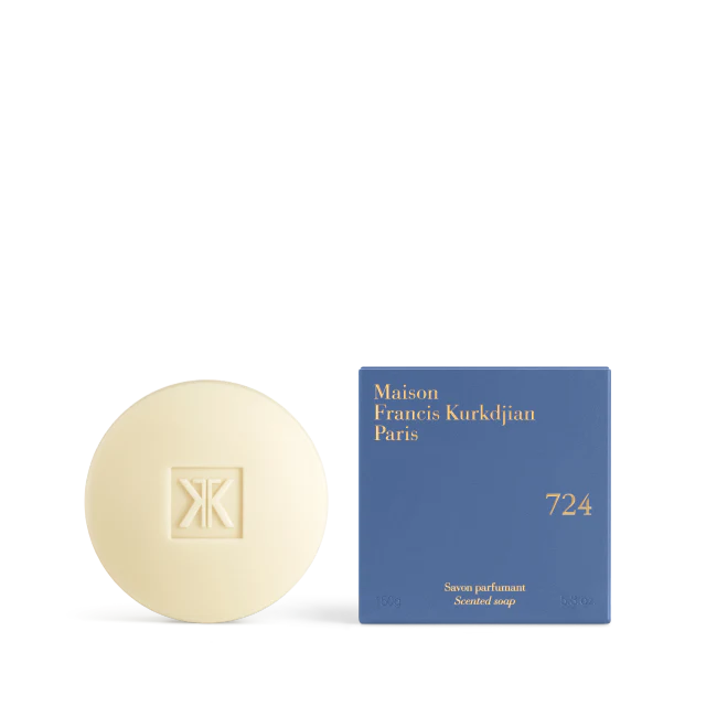 The Maison Francis Kurkdjian 724 scented soap bar displayed next to its vibrant blue square packaging with gold-stamped lettering.