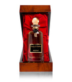 The Patchouli Sublime carafe presented inside an opened, high-gloss lacquered wooden case with a plush red velvet interior.