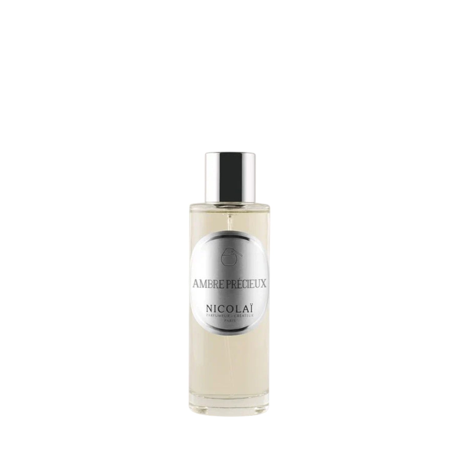 A 100ml clear cylindrical glass bottle of Nicolai Ambre Précieux Home Spray. The bottle features a sleek silver-tone cap and a circular silver label.