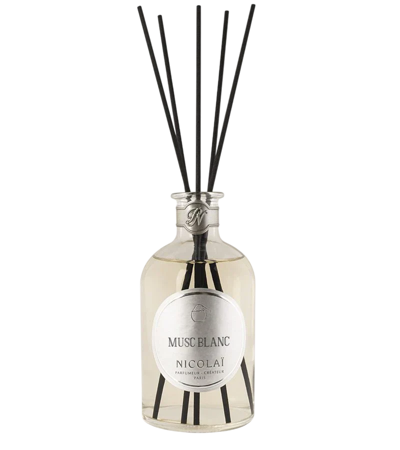 Nicolai Musc Blanc diffuser bottle with black reeds on a white background.