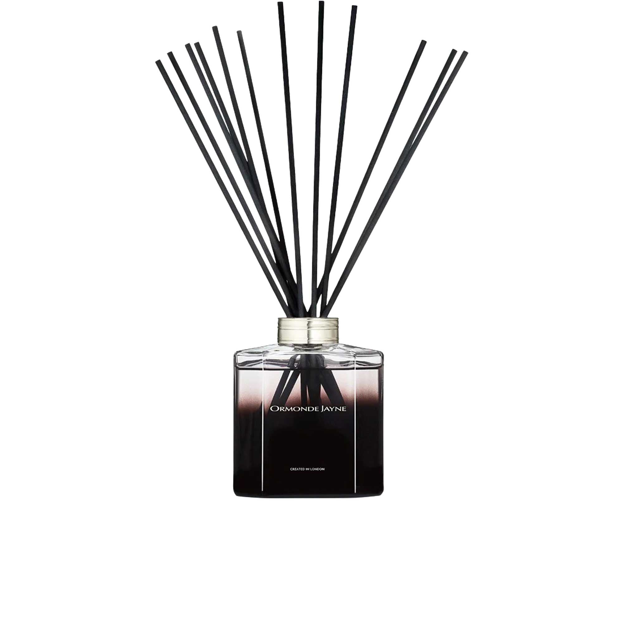 A 500ml Ormonde Jayne luxury reed diffuser featuring a square clear glass bottle filled with dark liquid, a silver collar, and a fanned-out arrangement of black reeds.