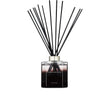 A 500ml Ormonde Jayne luxury reed diffuser featuring a square clear glass bottle filled with dark liquid, a silver collar, and a fanned-out arrangement of black reeds.