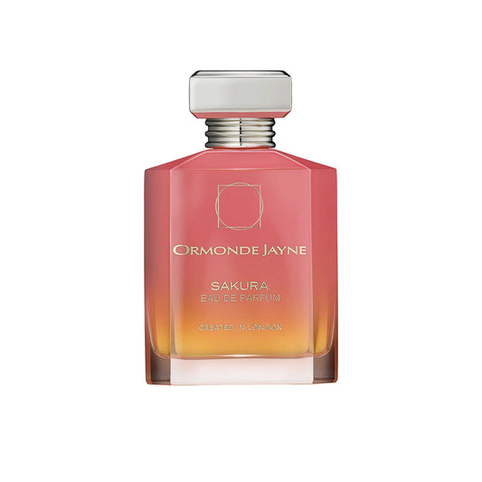 An 88ml orange and pink gradient glass bottle of Ormonde Jayne Sakura Eau de Parfum, featuring gold lettering and topped with a tiered silver neck and rectangular silver cap.