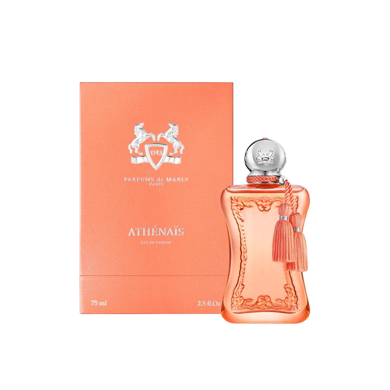 A luxury bottle of Parfums de Marly Athénaïs Eau de Parfum in 75ml next to its peach-colored textured box. The bottle is a frosted peach glass with ornate carvings, a silver spherical cap, and peach silk tassels. The box features the silver Parfums de Marly horse logo and the name "ATHÉNAÏS" in silver typography against a clean white background.