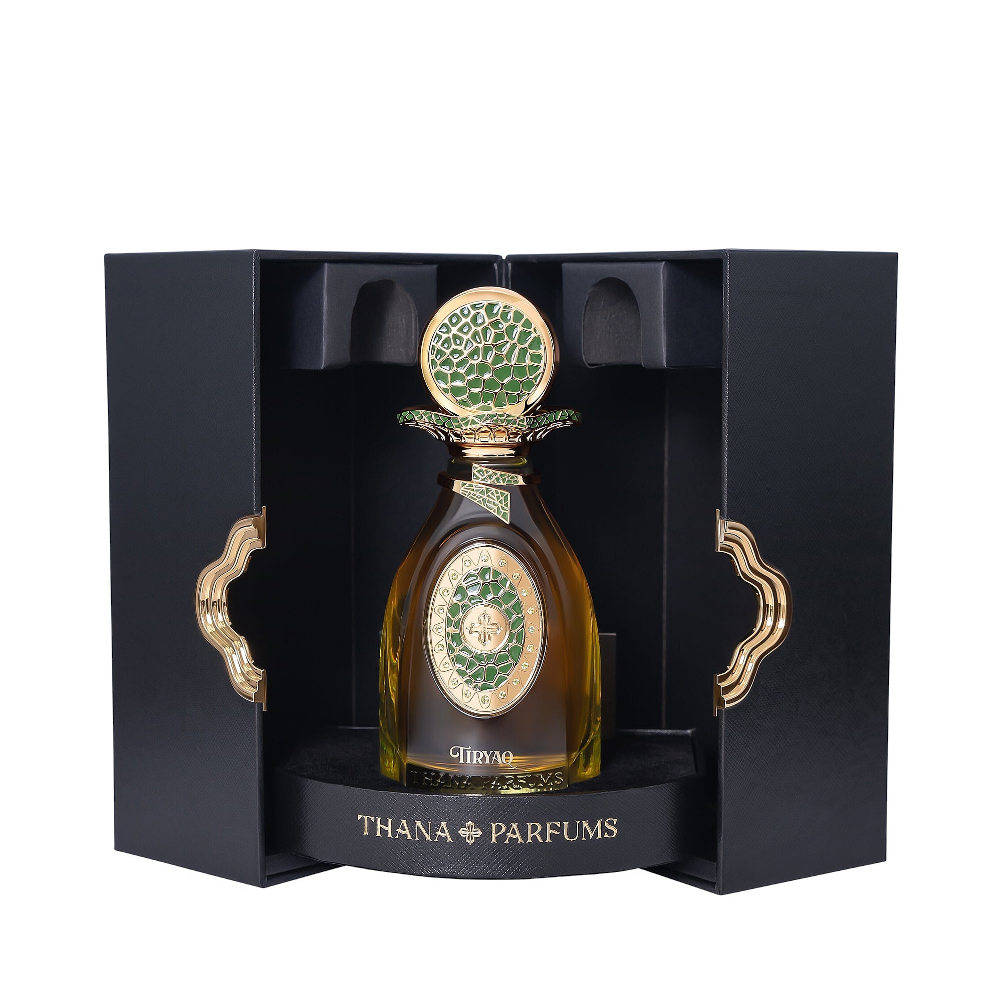 Amber perfume bottle with gold-toned cap and green mosaic details. In open black box with gold-toned wavy handles.