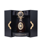 Dark amber perfume bottle with a gold-toned ornate cap and front design, displayed in a black textured box with gold-toned wa