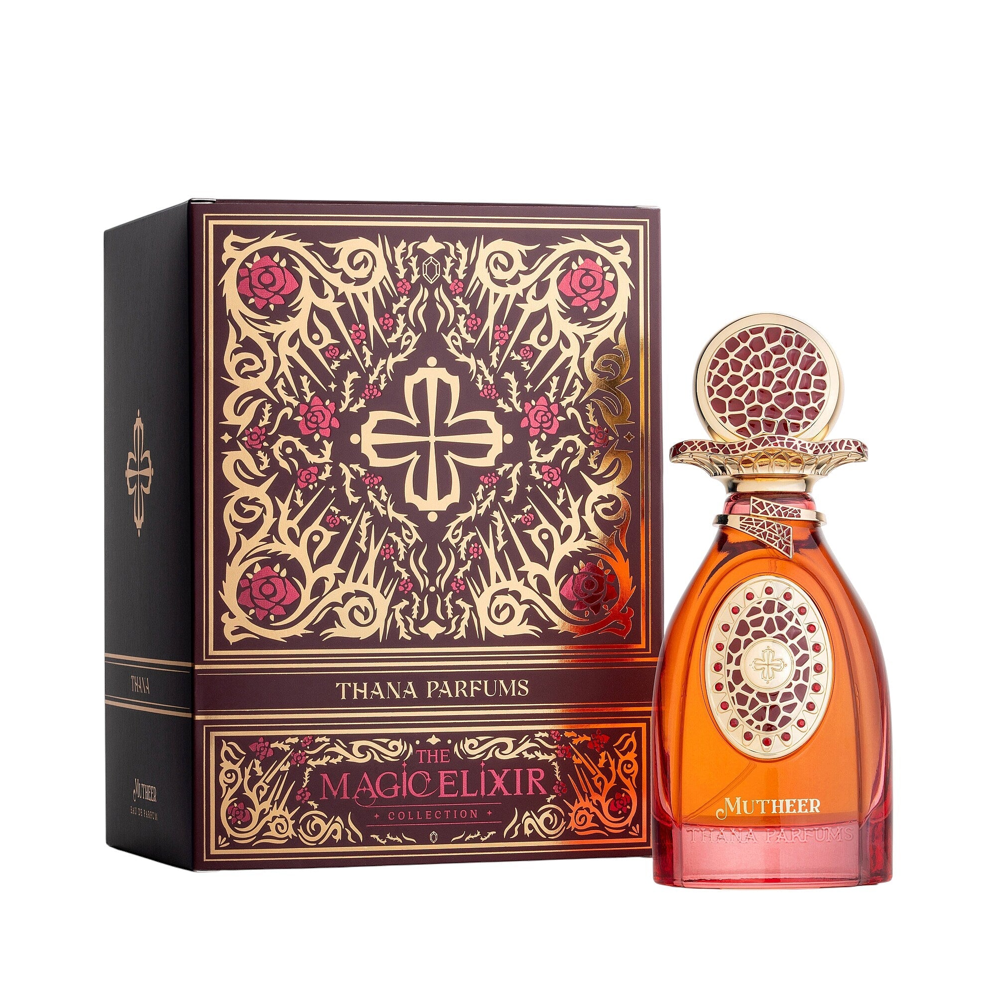 Amber-red perfume bottle with gold-toned ornate cap featuring a red insert, and a gold-toned emblem. Burgundy box with gold-t