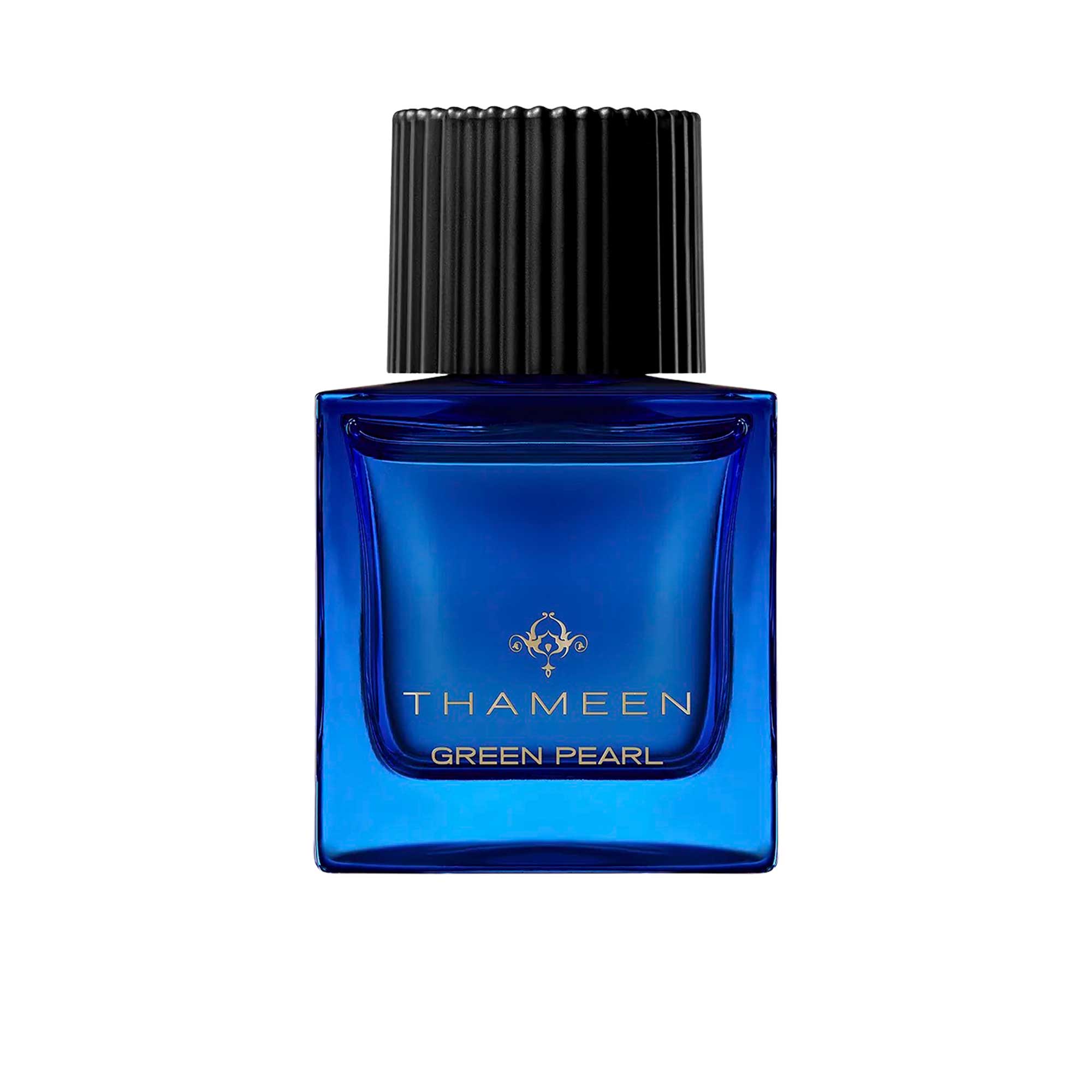 A 100ml square vibrant blue glass bottle of Thameen Green Pearl featuring gold lettering and topped with a textured black cylindrical cap.