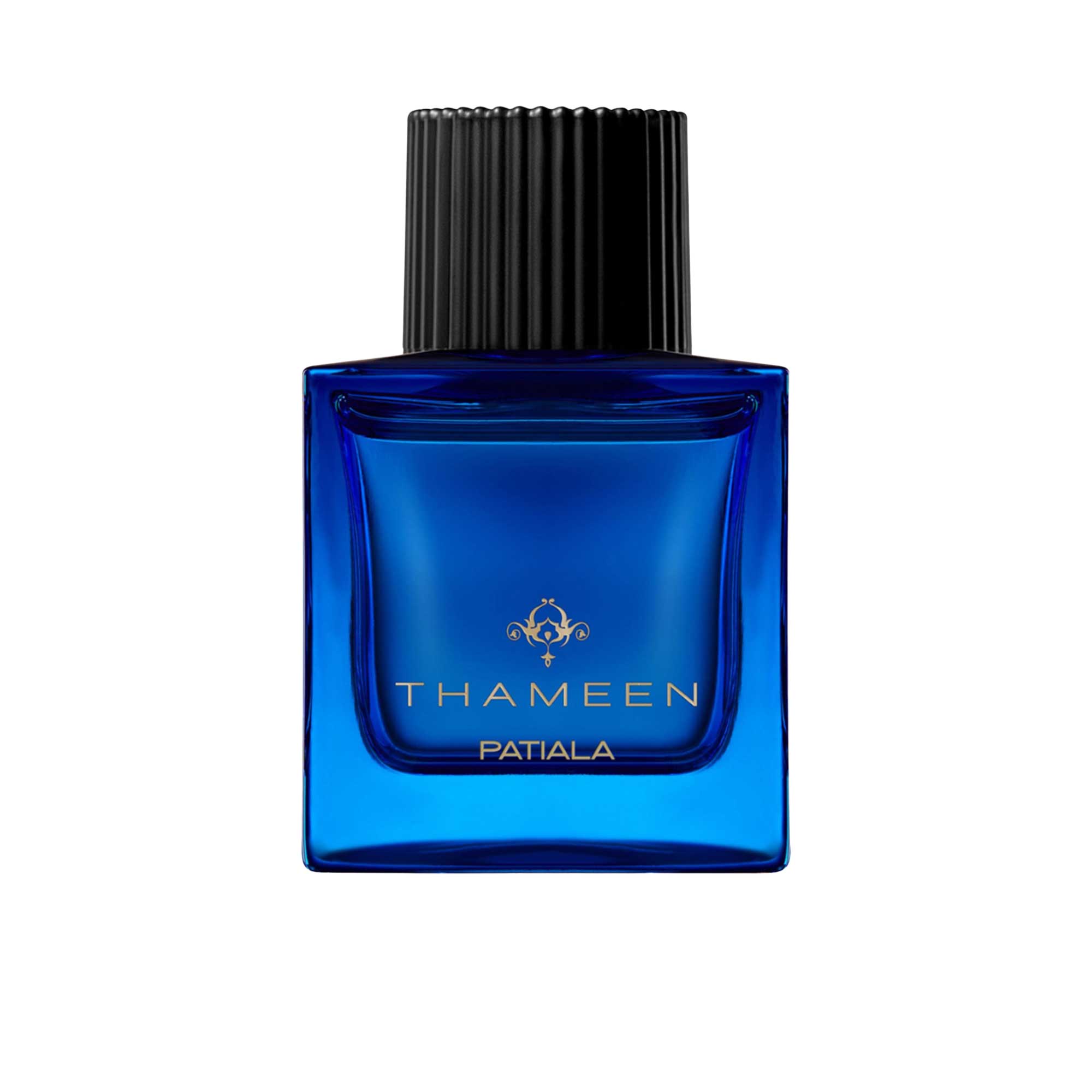 A 100ml square vibrant blue glass bottle of Thameen Patiala featuring gold lettering and topped with a textured black cylindrical cap.