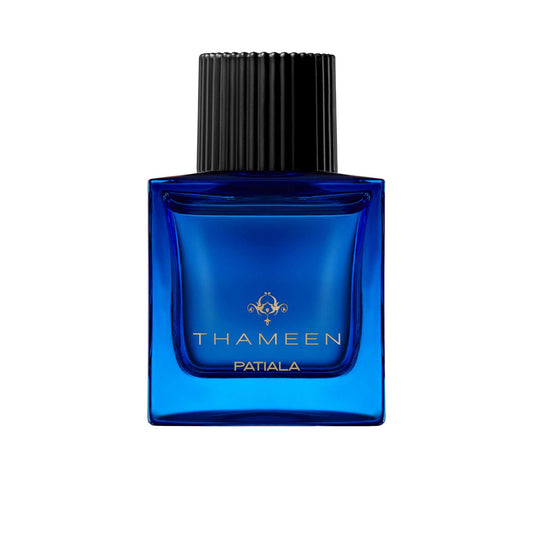 A 100ml square vibrant blue glass bottle of Thameen Patiala featuring gold lettering and topped with a textured black cylindrical cap.