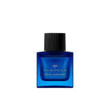 A 50ml square vibrant blue glass bottle of Thameen Royal Sapphire featuring gold lettering and topped with a textured black cylindrical cap.