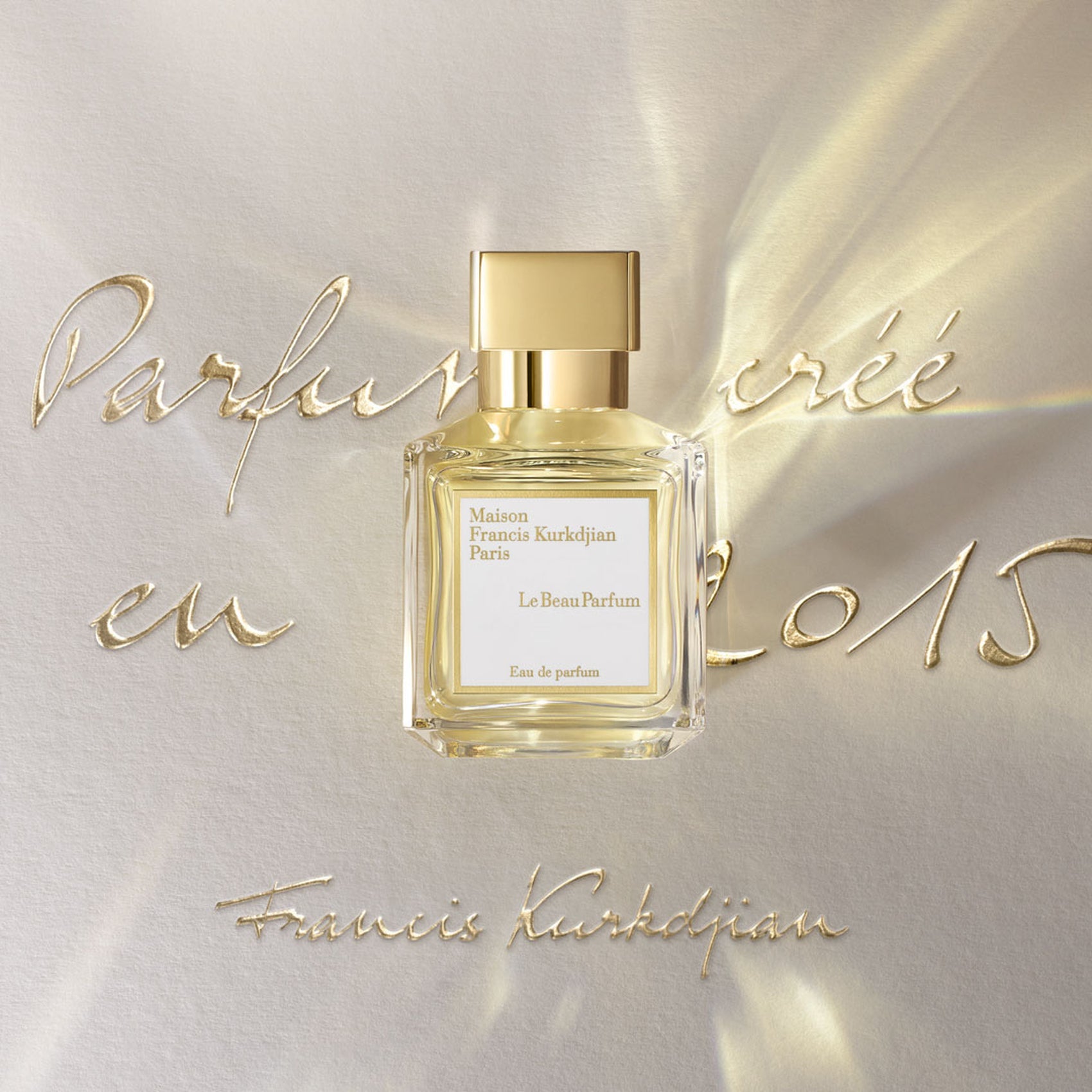 Rectangular clear glass perfume bottle with light yellow liquid, a gold-toned rectangular cap, and a white label.