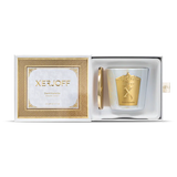 A close-up of the Dark Violette scented candle in a tapered purple glass holder, featuring an intricate gold star-patterned label and the embossed Xerjoff "X" logo.