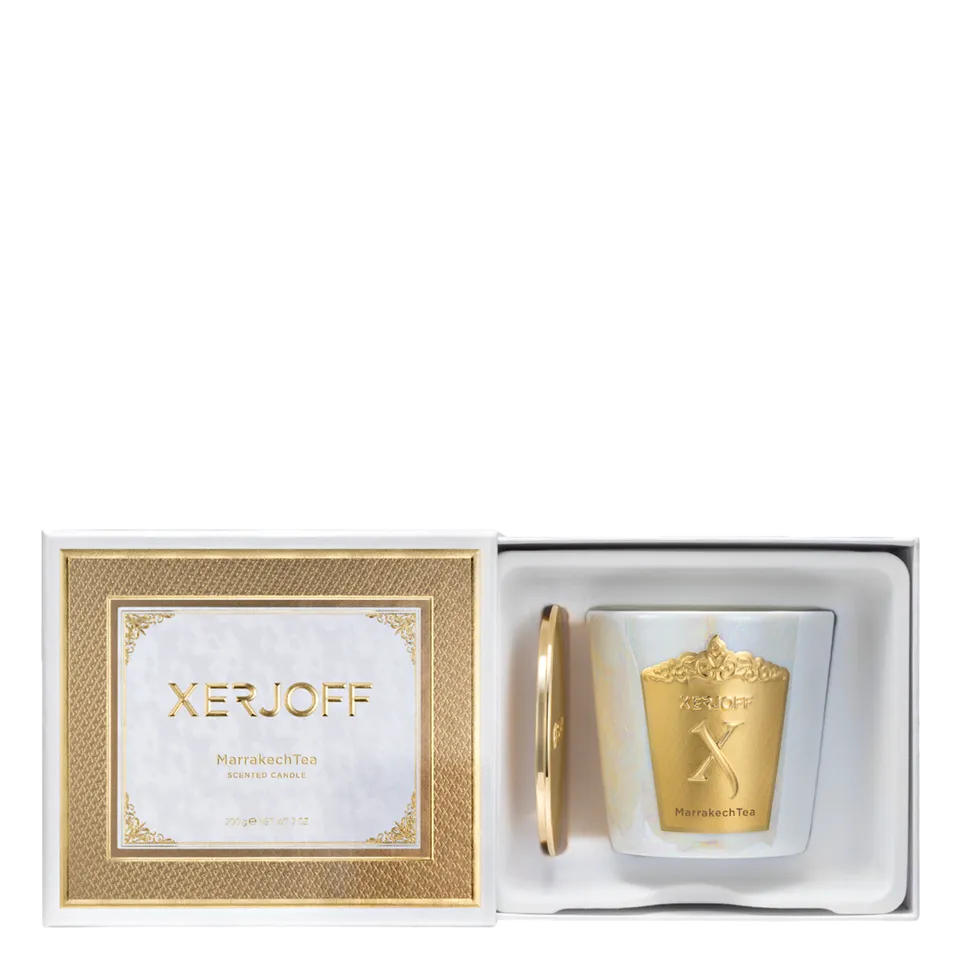 The luxury packaging for the Xerjoff Marrakech Tea candle, featuring a vibrant green and white marble-patterned box with gold-foil accents and the brand's signature "X" logo.