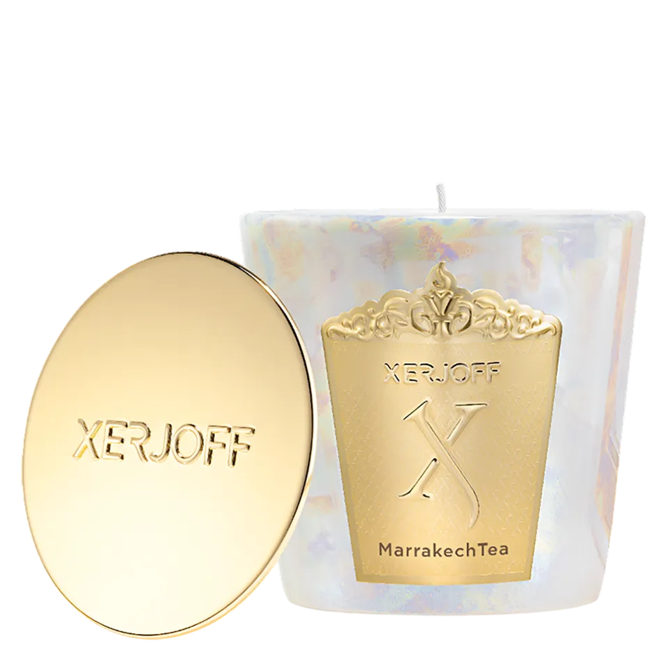 The Marrakech Tea scented candle in a tapered emerald green glass holder, showcasing a gold star-patterned label and the embossed Xerjoff emblem.