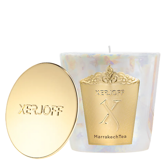 The Marrakech Tea scented candle in a tapered emerald green glass holder, showcasing a gold star-patterned label and the embossed Xerjoff emblem.