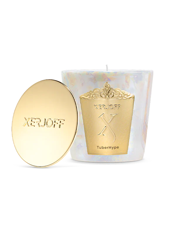 A Xerjoff TuberHype scented candle and its polished gold lid displayed inside a white luxury presentation box with a gold textured frame.