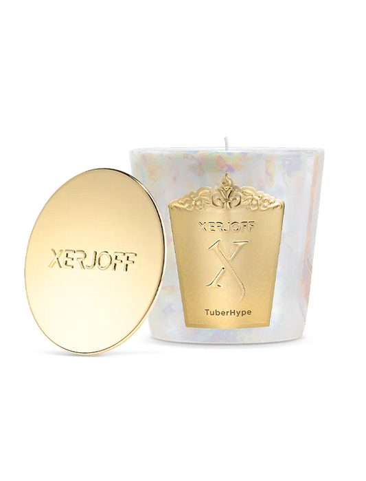 A Xerjoff TuberHype scented candle and its polished gold lid displayed inside a white luxury presentation box with a gold textured frame.