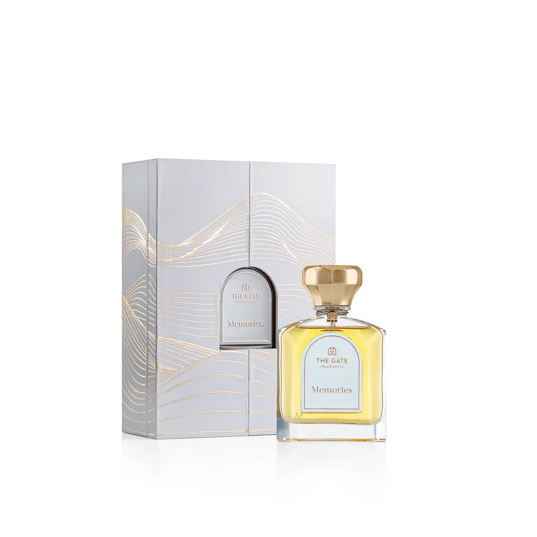 The Gate Fragrances Memories Extrait de Parfum bottle with gold cap and amber liquid displayed beside its elegant grey and gold box.